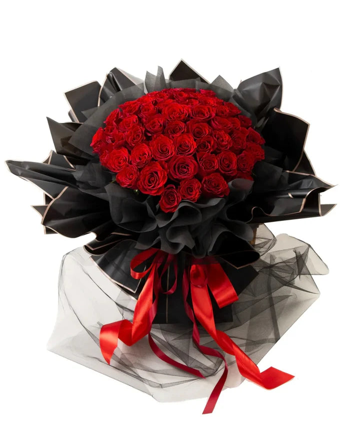 LUXURY RED 100 ROSES bouquet with vibrant red roses arranged elegantly in black wrapping.