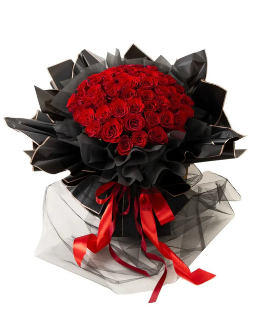 LUXURY RED 100 ROSES bouquet with vibrant red roses arranged elegantly in black wrapping.